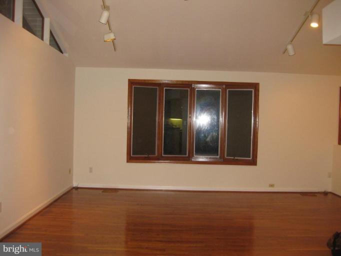 8455 Thames Street Springfield, VA 22151 - Photo 10 of 19 a view of an empty room with wooden floor and a window