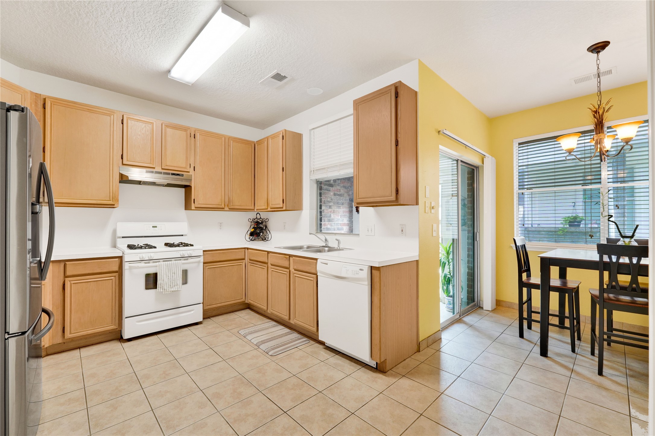 2923 Rising Sun Road Katy, TX 77449 - Photo 13 of 35 a kitchen with stainless steel appliances granite countertop a stove a sink and a refrigerator