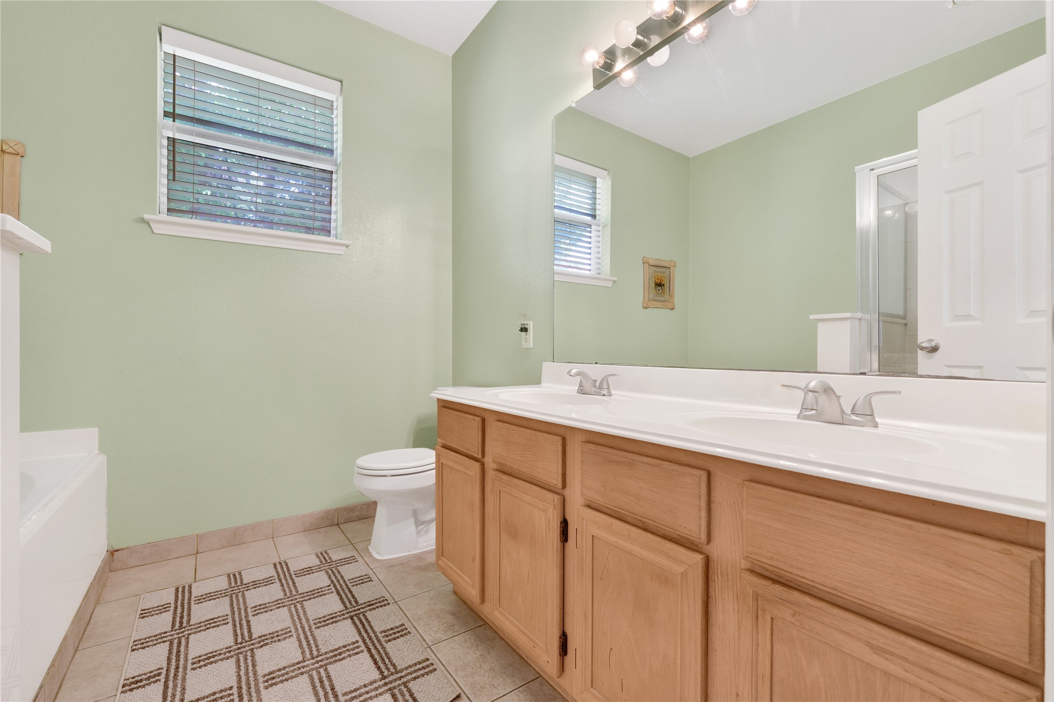 2923 Rising Sun Road Katy, TX 77449 - Photo 23 of 35 a bathroom with a double vanity sink toilet and a mirror
