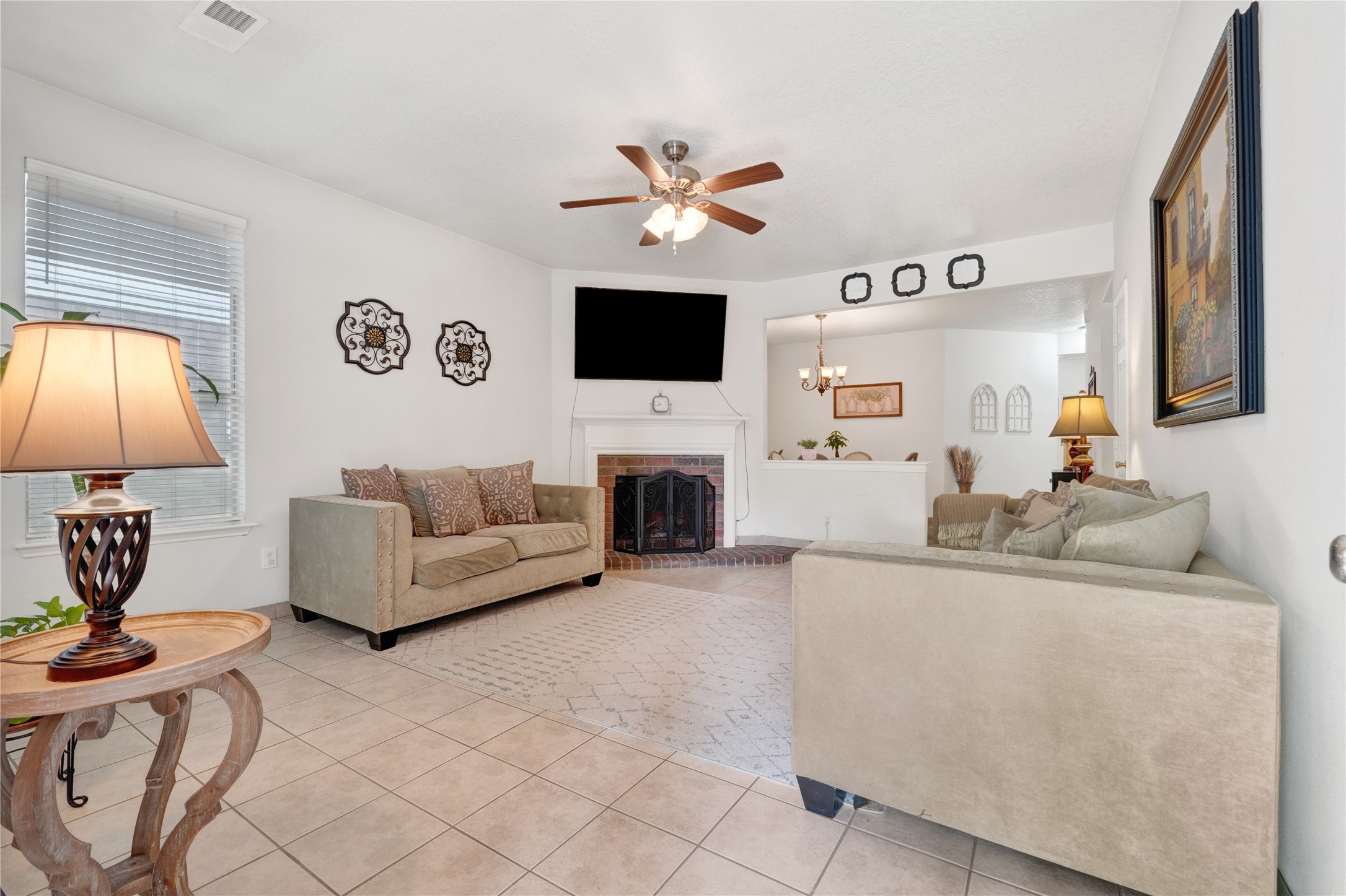 2923 Rising Sun Road Katy, TX 77449 - Photo 5 of 35 a living room with furniture a flat screen tv and a fireplace