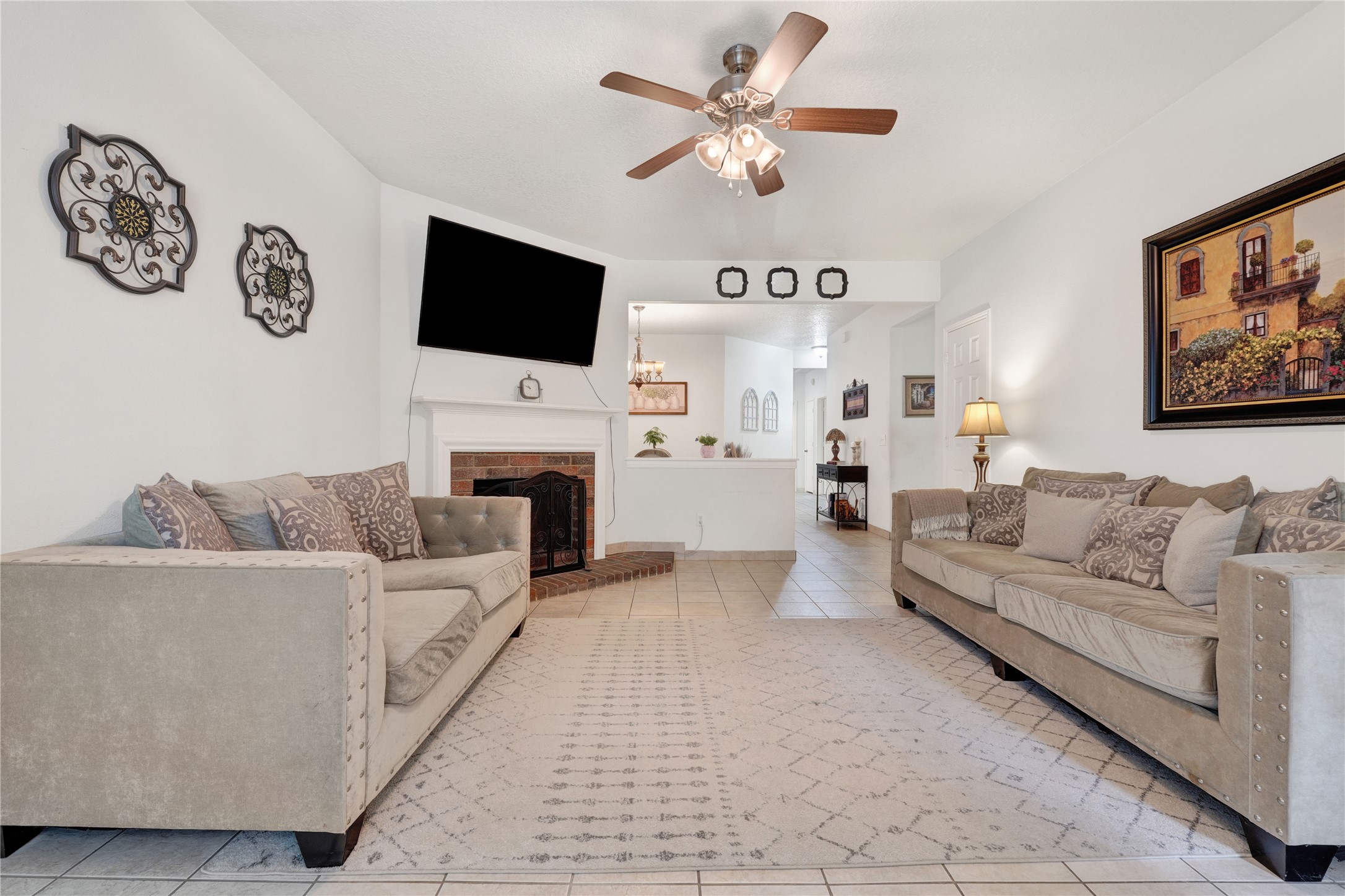 2923 Rising Sun Road Katy, TX 77449 - Photo 6 of 35 a living room with furniture a flat screen tv and a fireplace