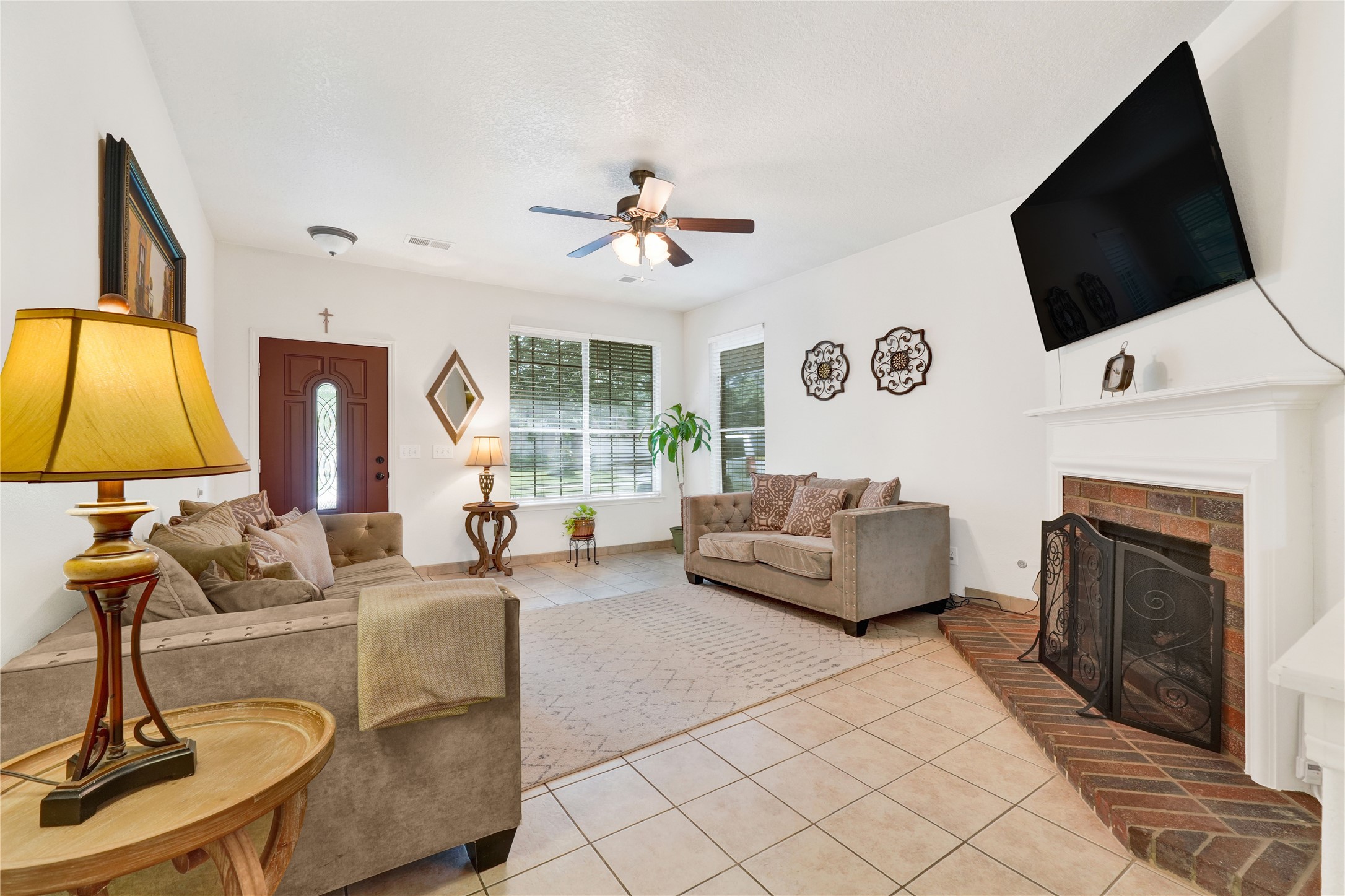 2923 Rising Sun Road Katy, TX 77449 - Photo 9 of 35 a living room with fireplace furniture and a flat screen tv