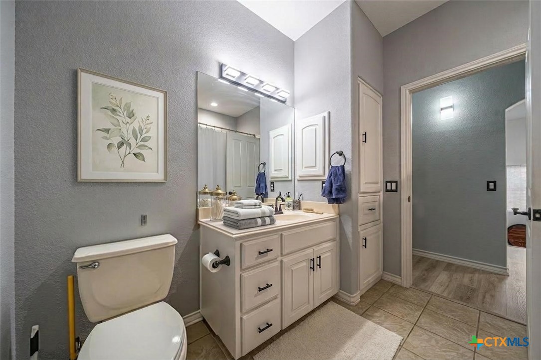 519 Long Meadow Spring Branch, TX 78070 - Photo 23 of 33 a bathroom with a toilet sink and mirror