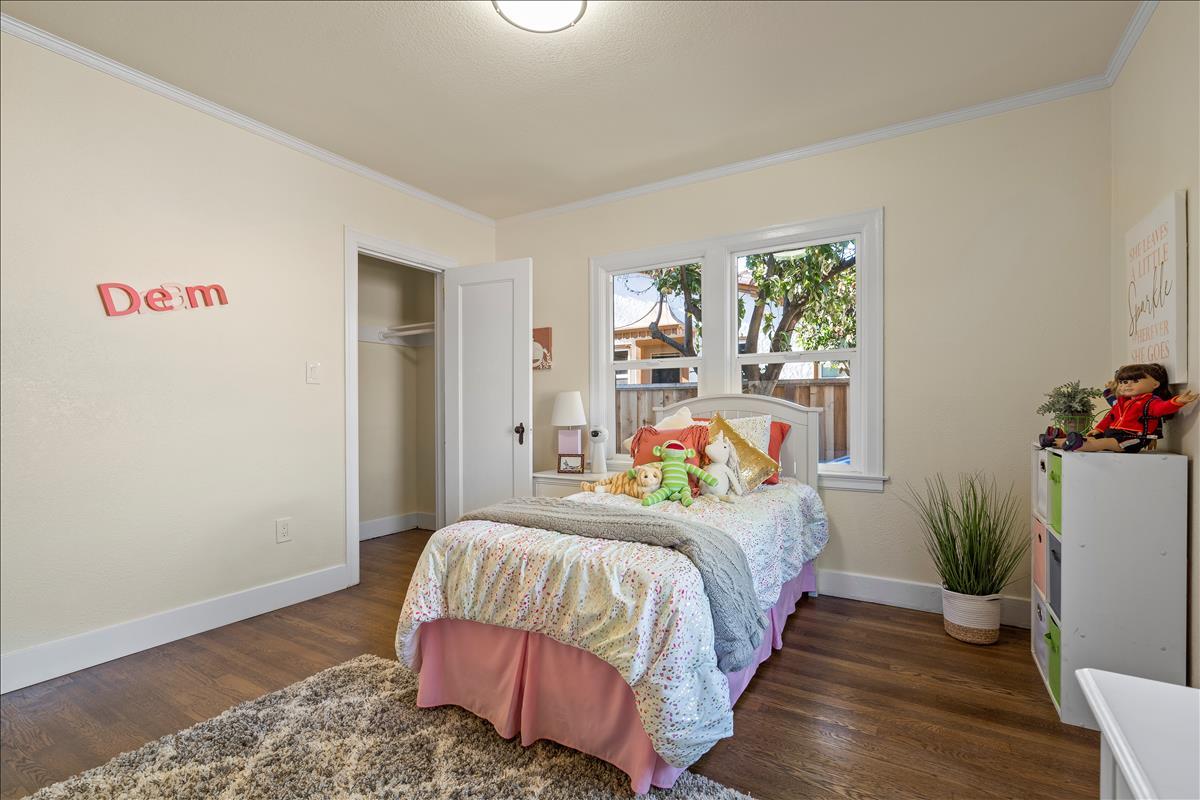 1145 Clark Way San Jose, CA 95125 - Photo 17 of 26 a bedroom with a bed and a potted plant