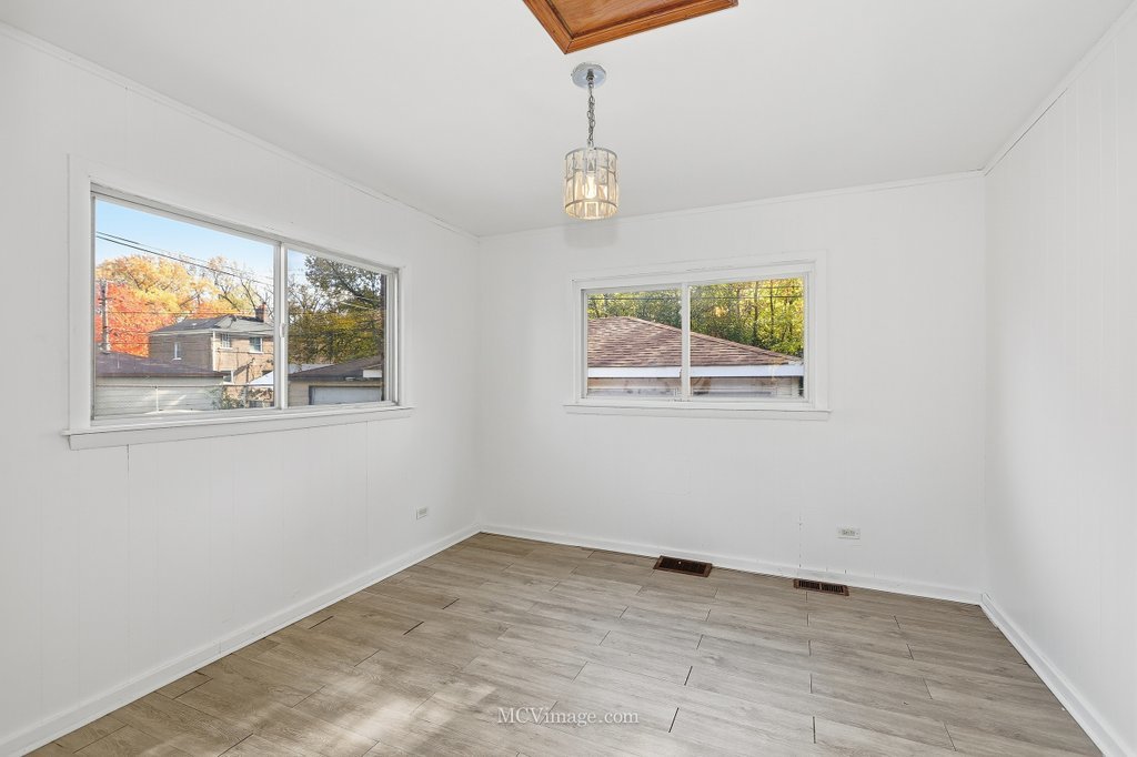 2161 East 97th Street Chicago, IL 60617 - Photo 7 of 13 an empty room with windows