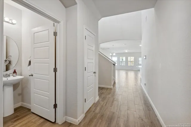 a view of a hallway with wooden floor and staircase