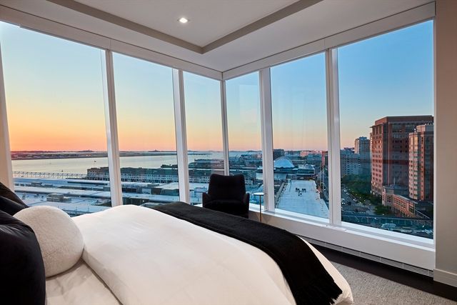 a bedroom with a large bed and a balcony view