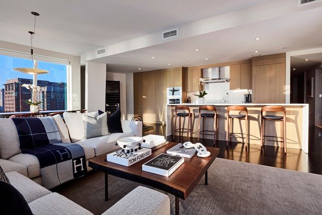 a living room with furniture a rug and a chandelier