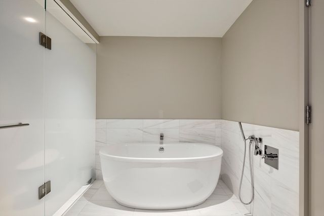 a white bath tub sitting in a bathroom