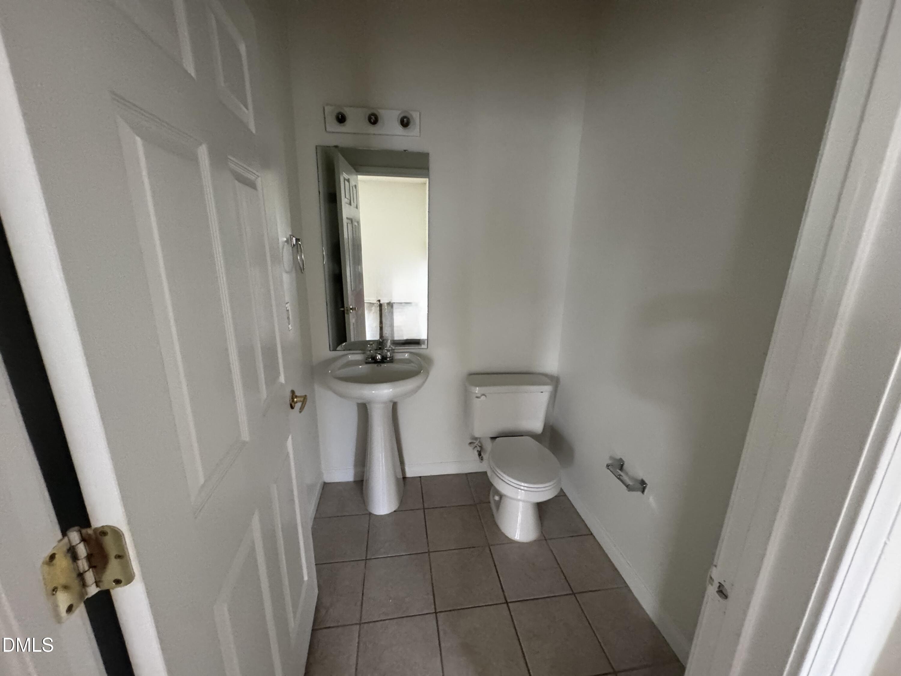 2511 Friedland Place, Unit 202 Raleigh, NC 27617 - Photo 11 of 19 a bathroom with a toilet and a mirror