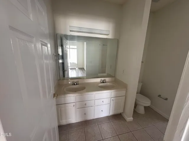 a bathroom with a granite countertop bathtub shower and toilet