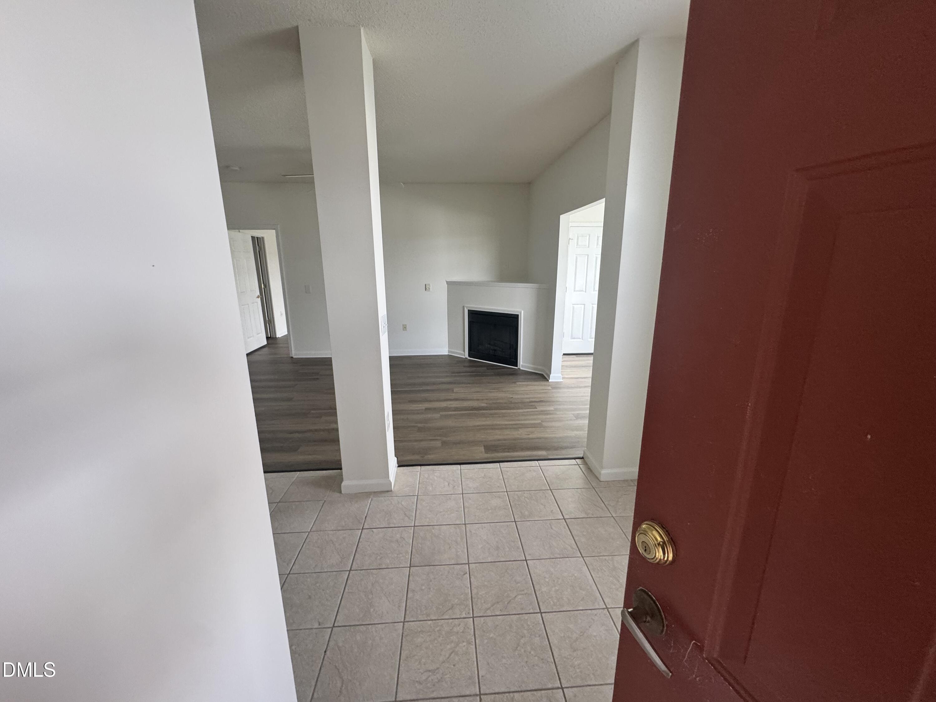 2511 Friedland Place, Unit 202 Raleigh, NC 27617 - Photo 2 of 19 a view of a hallway with wooden cabinets and fireplace