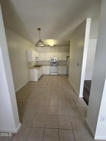 a white refrigerator freezer and a cabinets