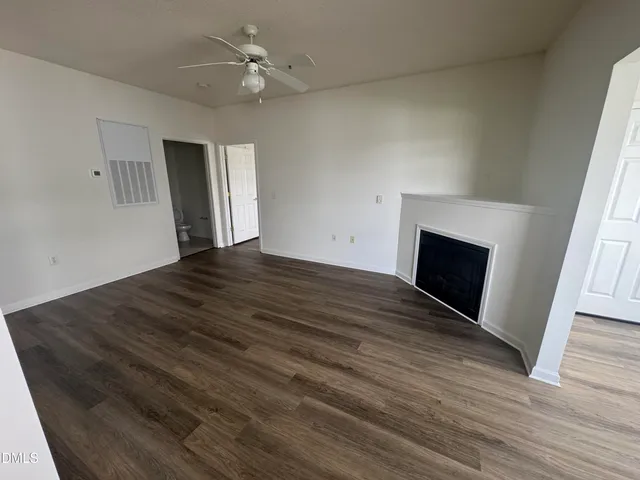 wooden floor in an empty room with a fireplace