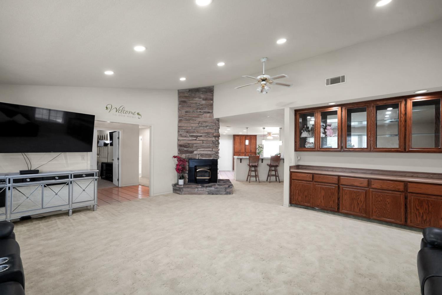 2195 Brigadoon Walk Manteca, CA 95336 - Photo 11 of 41 a large living room with fireplace furniture and a flat screen tv