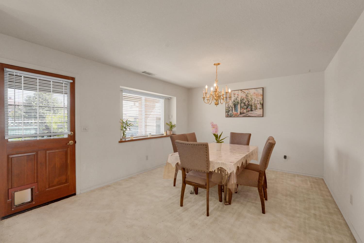 2195 Brigadoon Walk Manteca, CA 95336 - Photo 13 of 41 a view of a dining room with furniture and chandelier