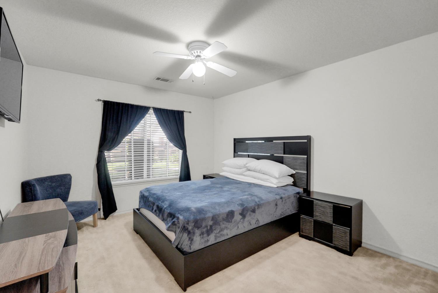2195 Brigadoon Walk Manteca, CA 95336 - Photo 17 of 41 a bedroom with a large bed and a window