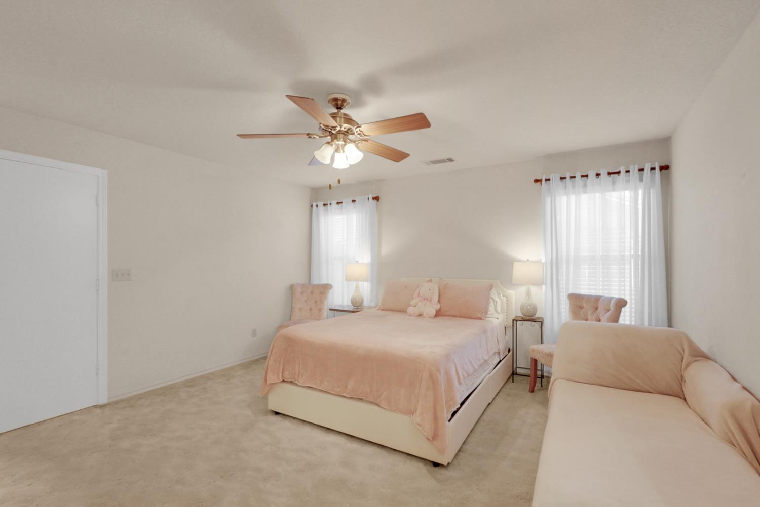 2195 Brigadoon Walk Manteca, CA 95336 - Photo 19 of 41 a bedroom with a large bed chandelier and a window