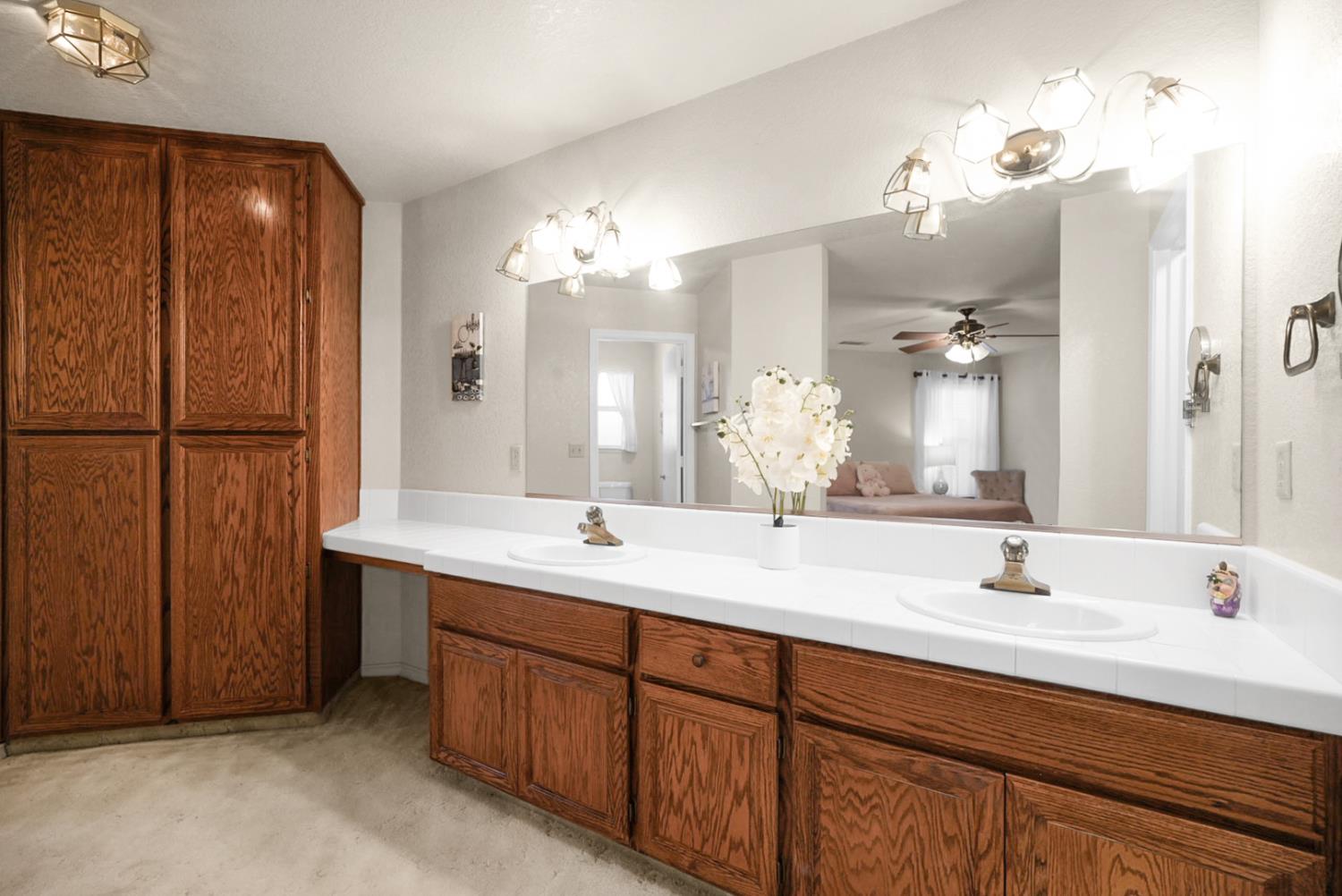 2195 Brigadoon Walk Manteca, CA 95336 - Photo 20 of 41 a bathroom with a double vanity sink and a mirror