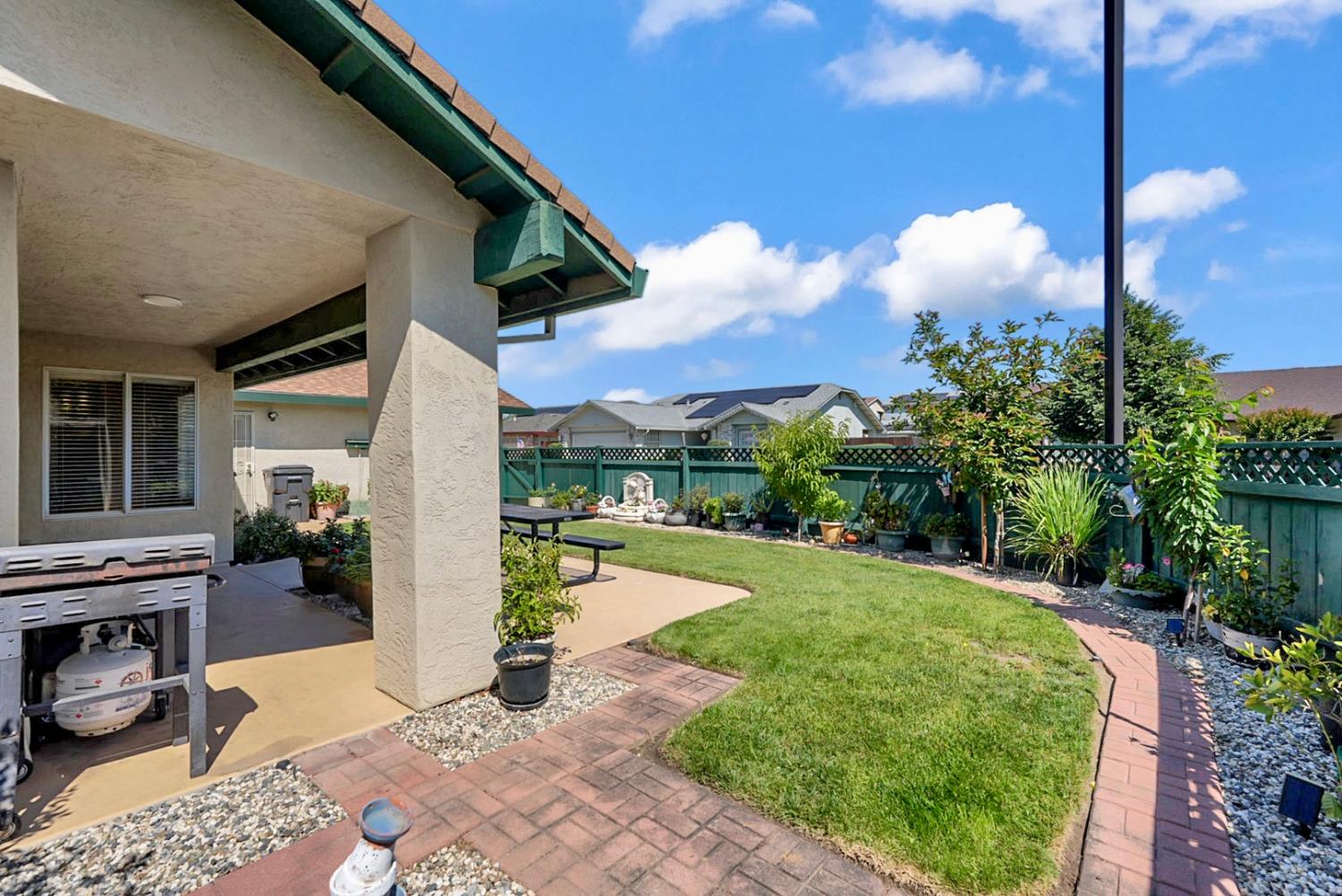 2195 Brigadoon Walk Manteca, CA 95336 - Photo 24 of 41 a view of a patio with table and chairs potted plants