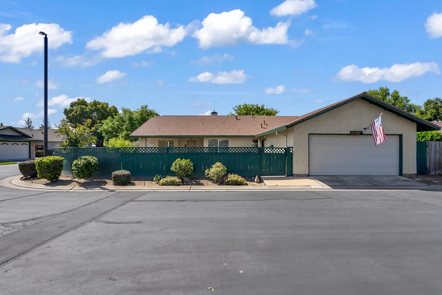 2195 Brigadoon Walk Manteca, CA 95336 - Photo 27 of 41 a front view of a house with a garden and patio