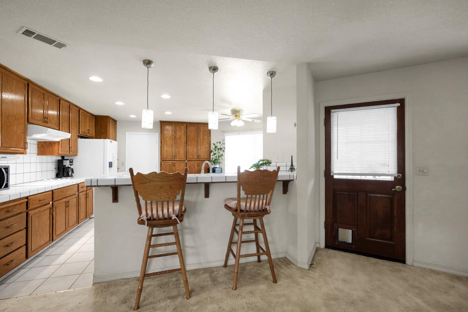2195 Brigadoon Walk Manteca, CA 95336 - Photo 5 of 41 a view of kitchen with cabinets table and chairs