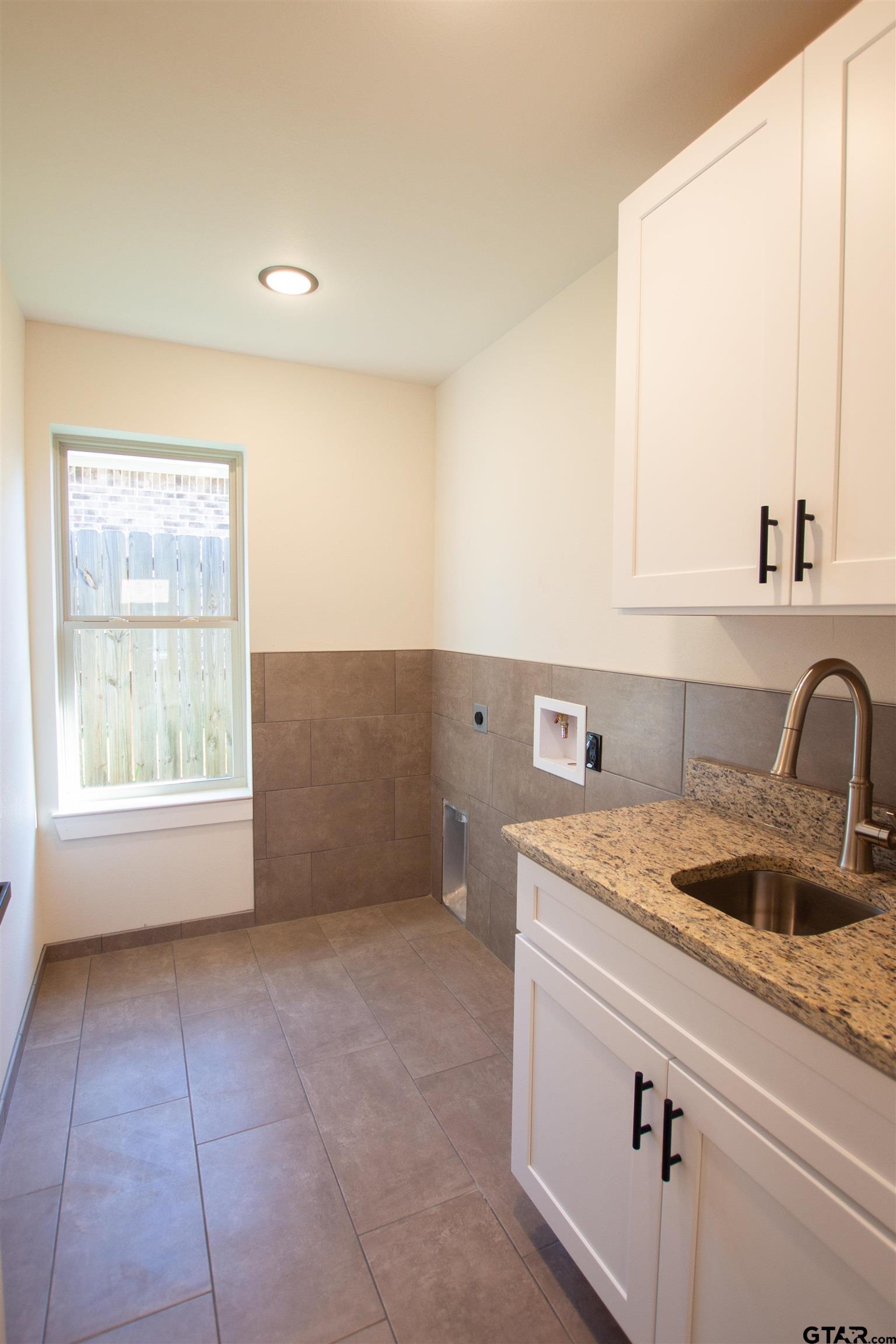 1108 Park Street Tyler, TX 75702 - Photo 12 of 27 view of kitchen with granite countertop a sink and a stove
