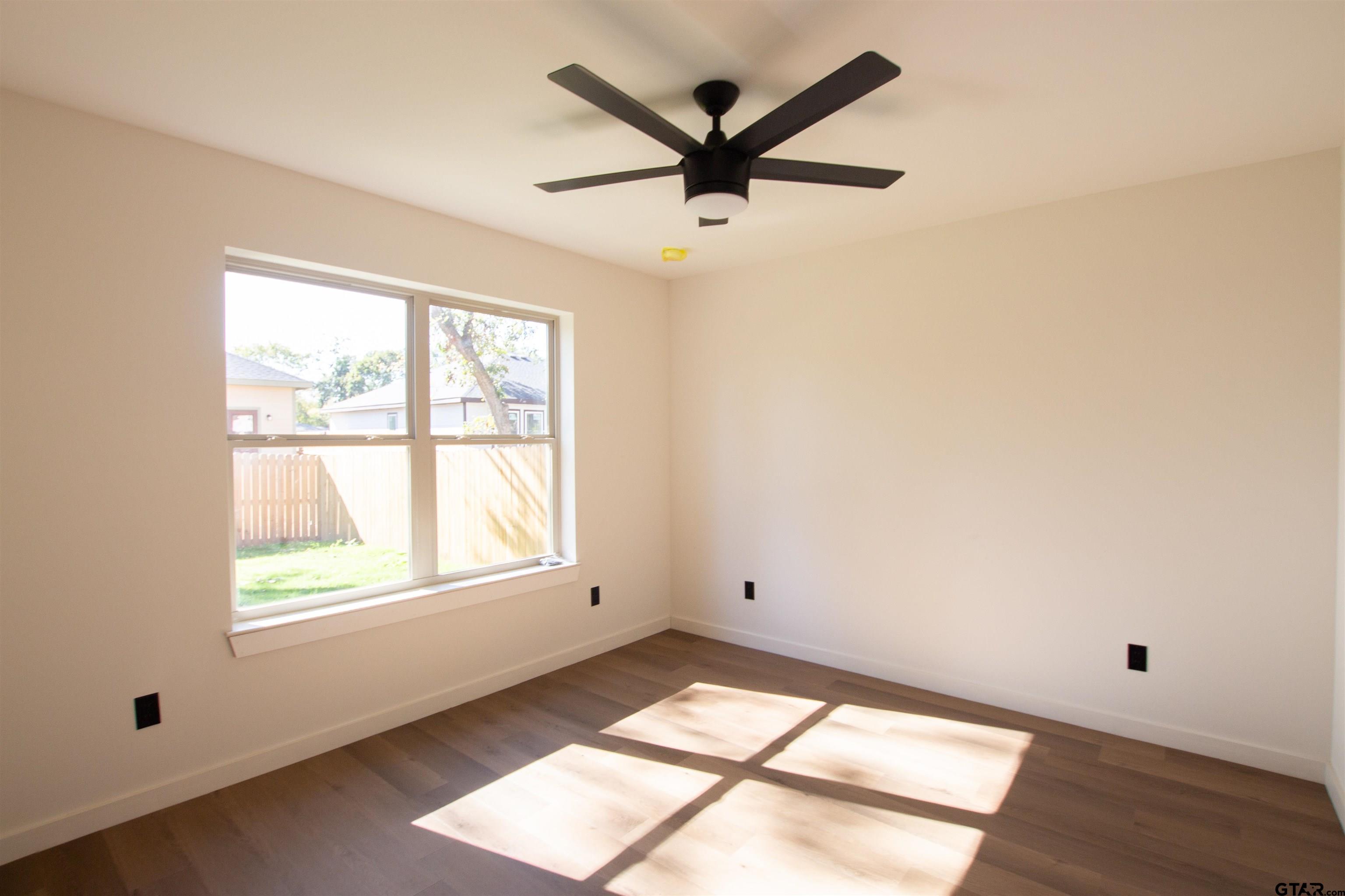 1108 Park Street Tyler, TX 75702 - Photo 18 of 27 a view of empty room with wooden floor and fan