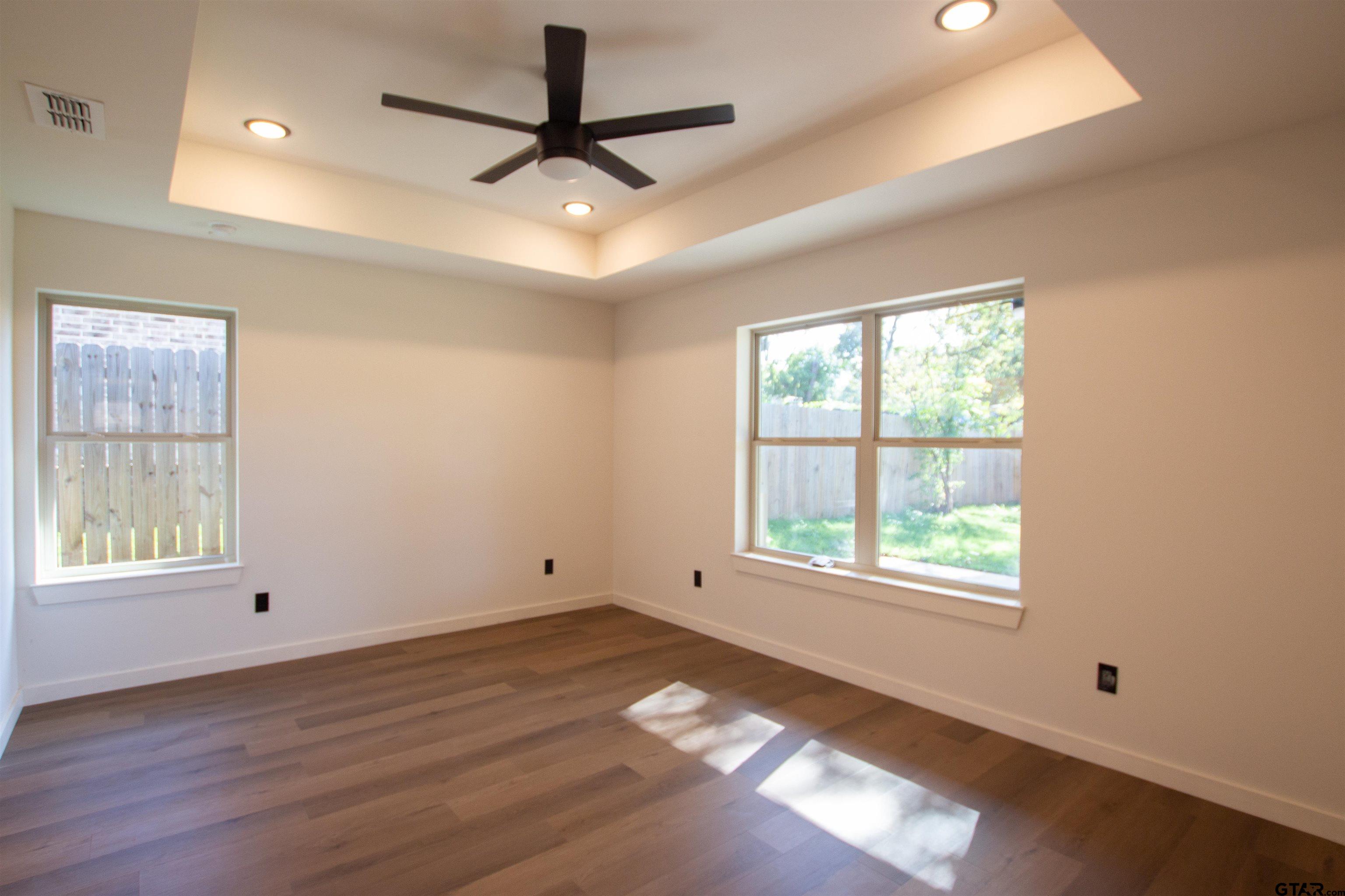 1108 Park Street Tyler, TX 75702 - Photo 19 of 27 a view of an empty room with wooden floor and a window