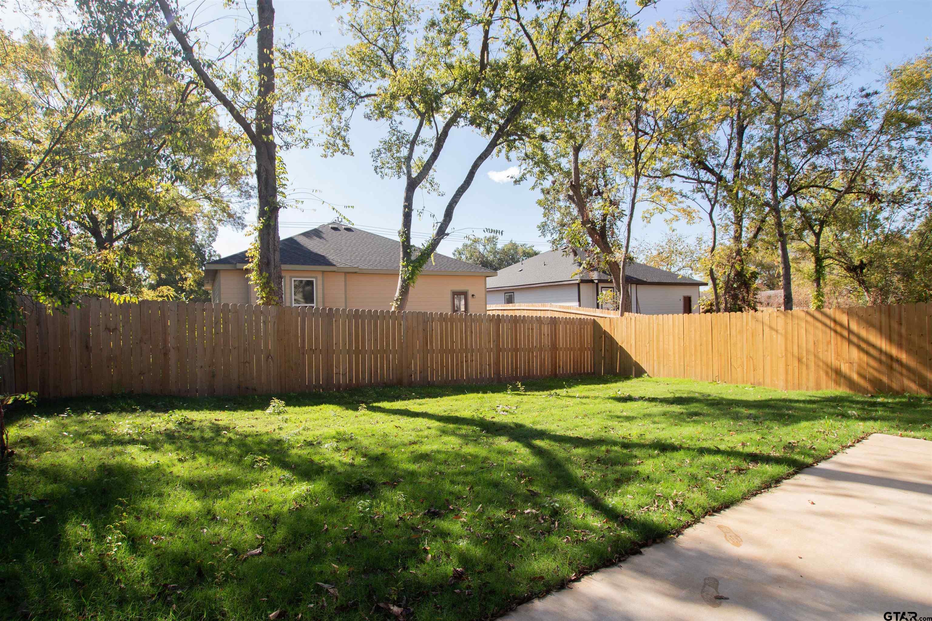 1108 Park Street Tyler, TX 75702 - Photo 26 of 27 a view of a backyard with wooden fence