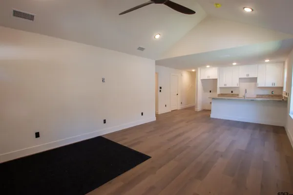 an empty room with wooden floor