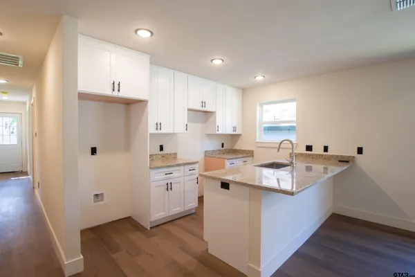 a kitchen with appliances a sink and cabinets