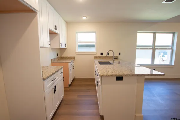 a kitchen with a sink cabinets and window