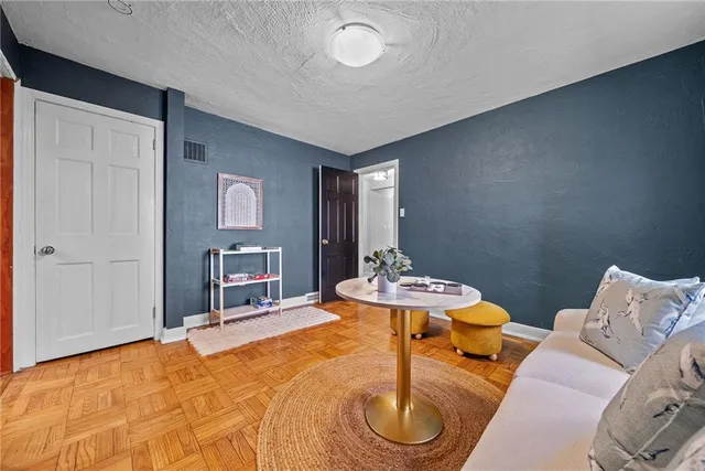 a living room with furniture and a dining table