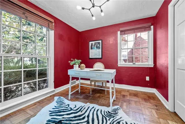 a living room with furniture a window and a potted plant