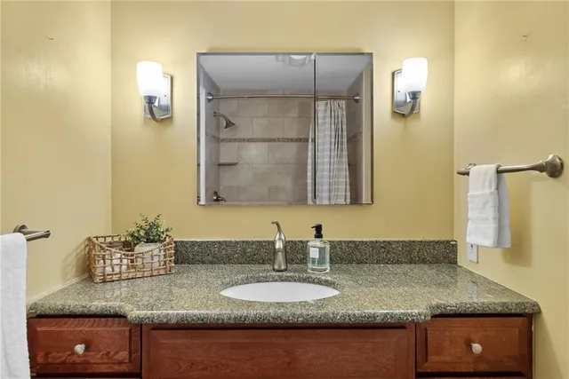 a bathroom with sinks granite countertop and a mirror