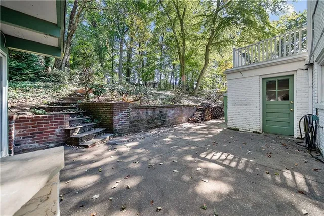 a backyard of a house with barbeque oven and outdoor seating