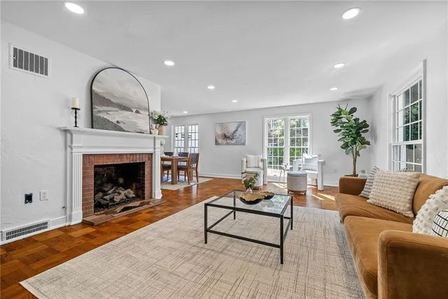 a living room with furniture and a fireplace