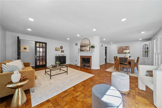 a living room with furniture fireplace and dining table