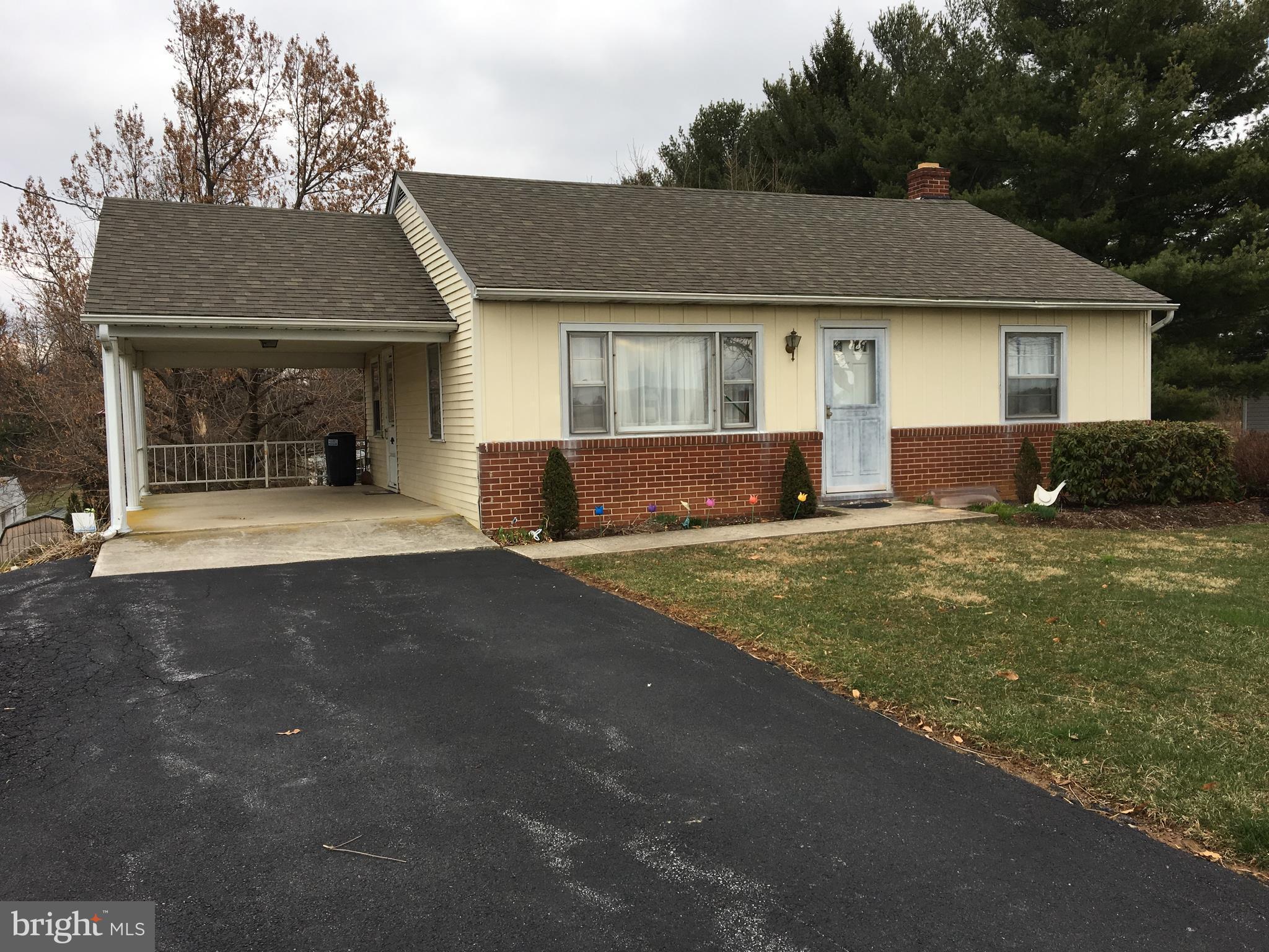 4504 Maple Grove Road Hampstead, MD 21074 - Photo 1 of 12 a front view of a house with a yard and garage