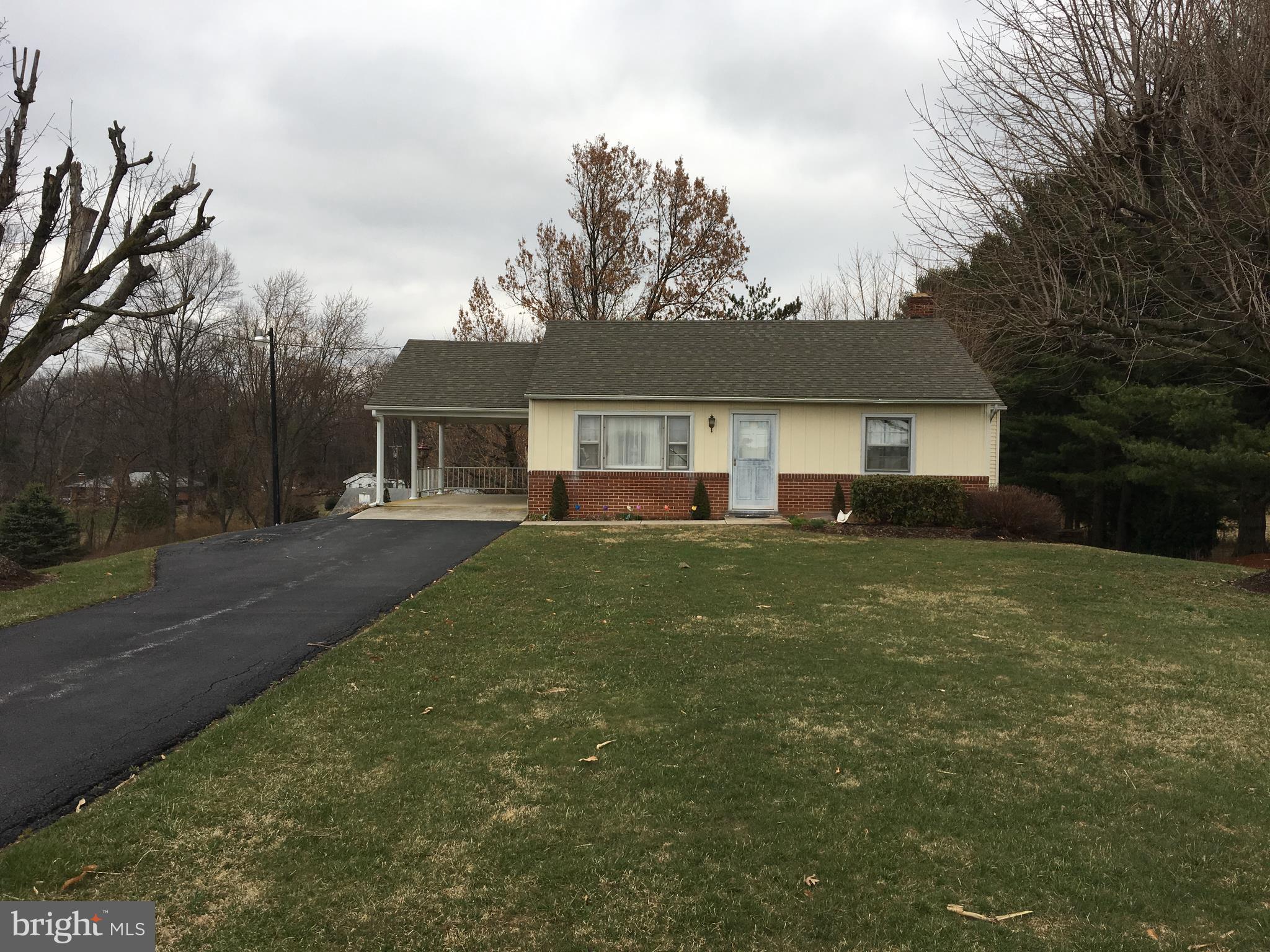 4504 Maple Grove Road Hampstead, MD 21074 - Photo 2 of 12 a front view of a house with a yard
