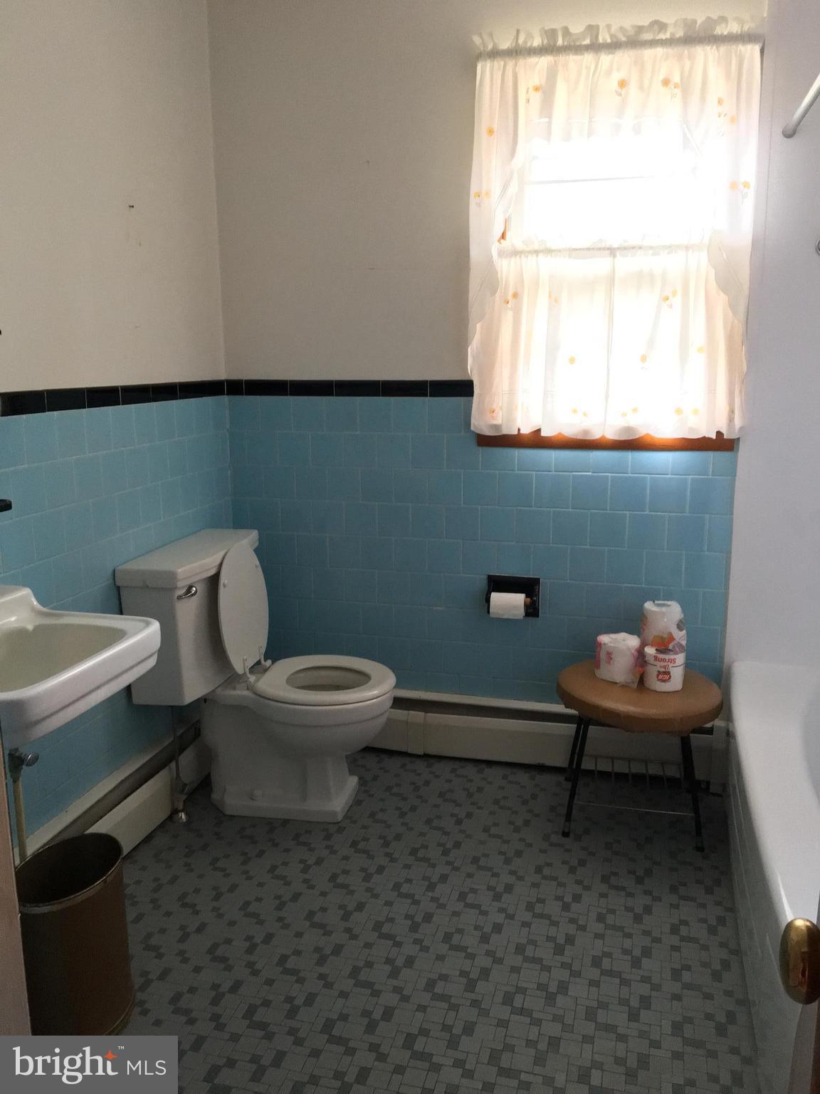 4504 Maple Grove Road Hampstead, MD 21074 - Photo 11 of 12 a bathroom with a toilet a sink and a window