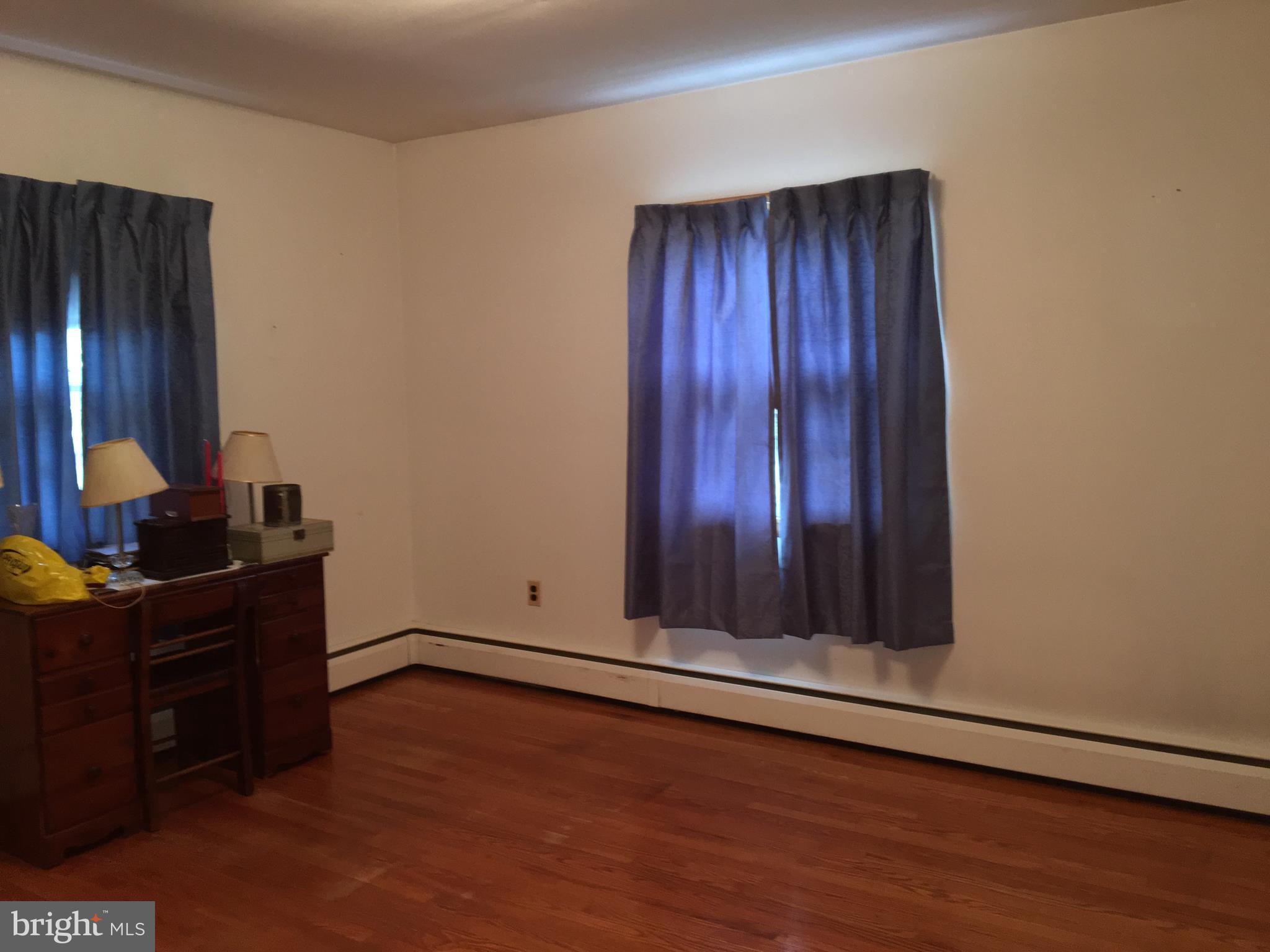 4504 Maple Grove Road Hampstead, MD 21074 - Photo 10 of 12 an empty room with wooden floor and windows