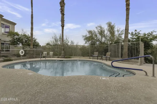 a view of swimming pool with outdoor seating and city view