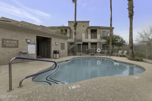 a view of a house with swimming pool and sitting area