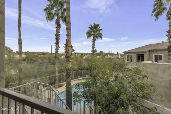 a view of a balcony with a tree