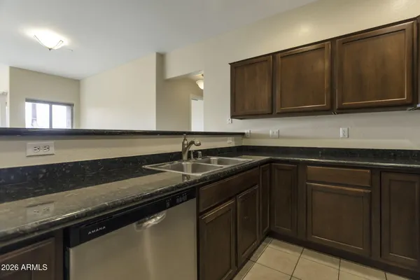a kitchen with granite countertop a sink and cabinets