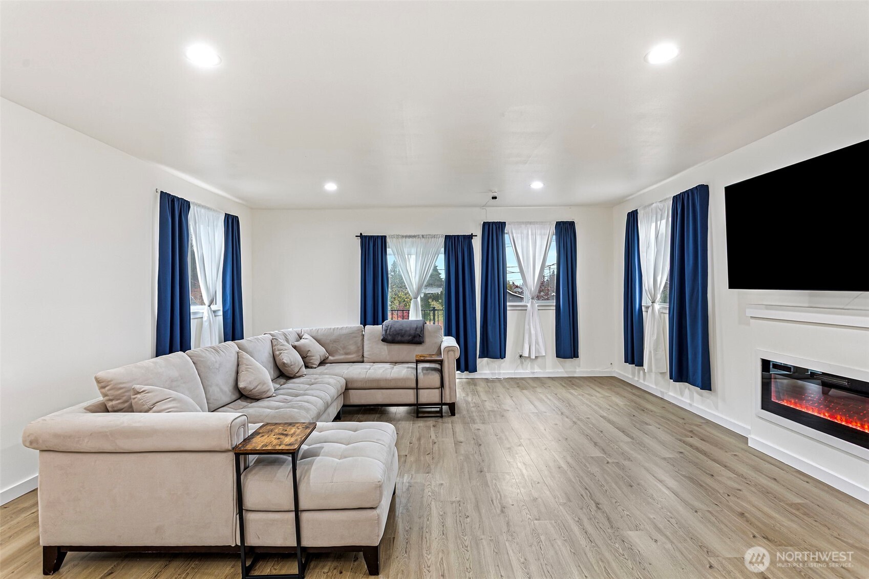 a living room with furniture and a flat screen tv