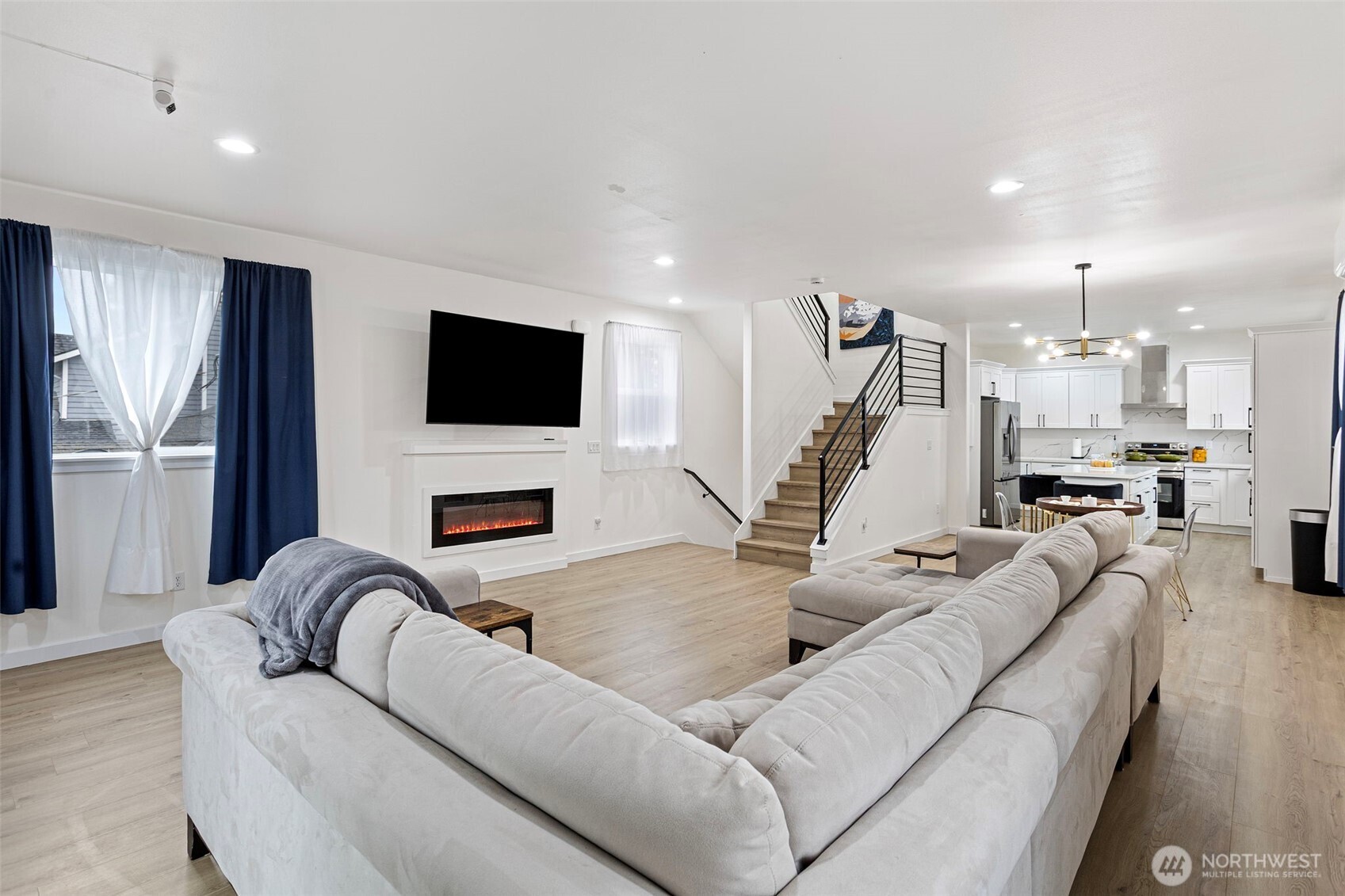 10615 2nd Place Southwest Seattle, WA 98146 - Photo 13 of 28 a living room with furniture a fireplace and a flat screen tv