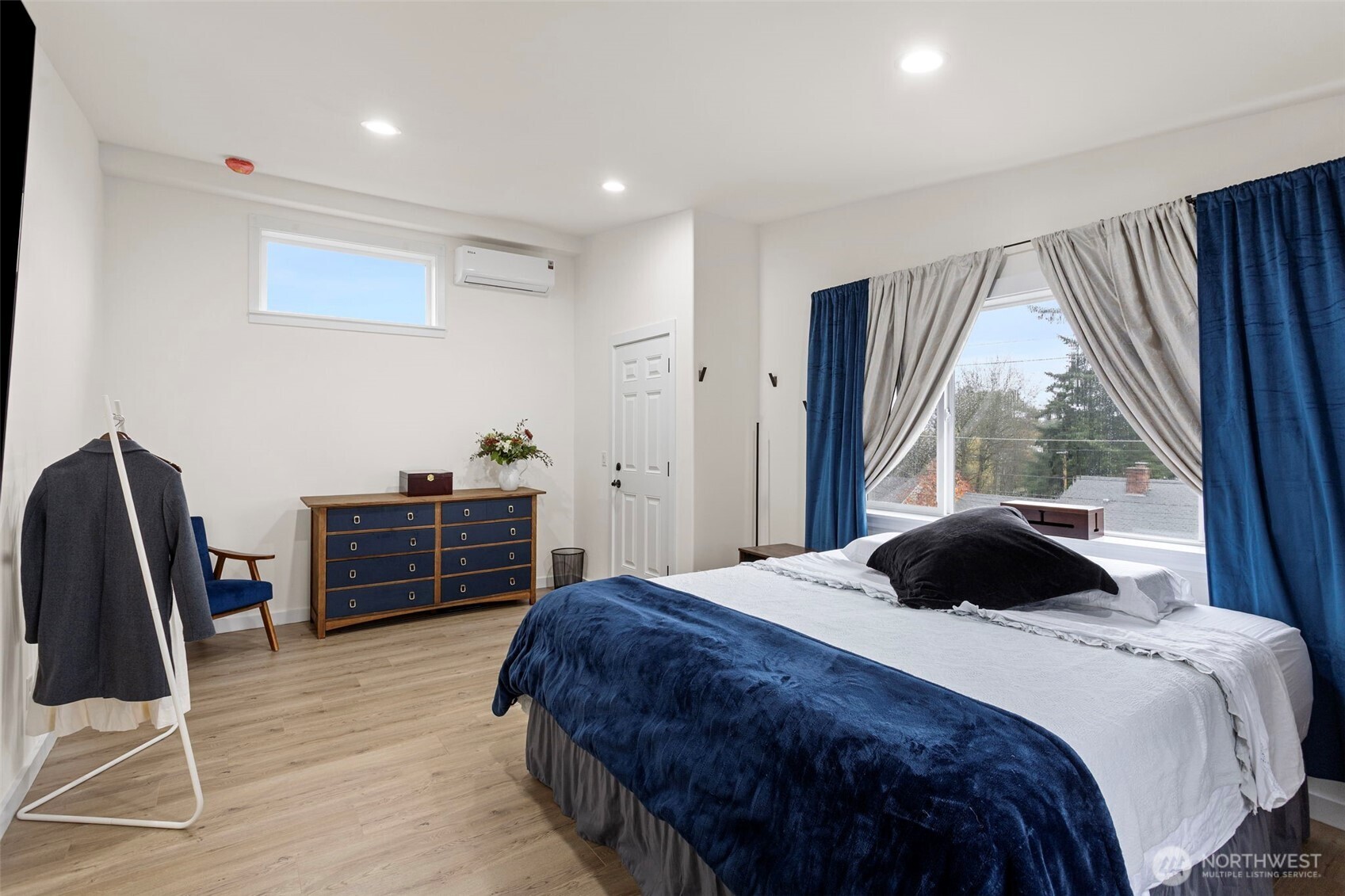 10615 2nd Place Southwest Seattle, WA 98146 - Photo 17 of 28 a bedroom with a bed and wooden floor